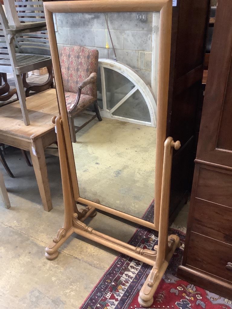 A large 19th century continental pale oak cheval mirror, with scrolling carved mounts, width 84cm, height 162cm